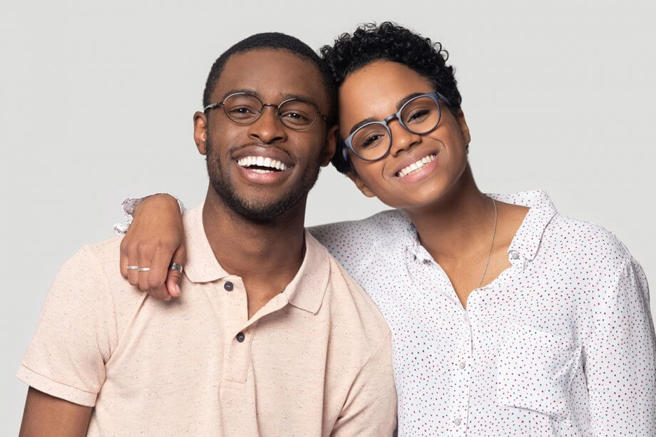 smiling woman with arm around smiling man